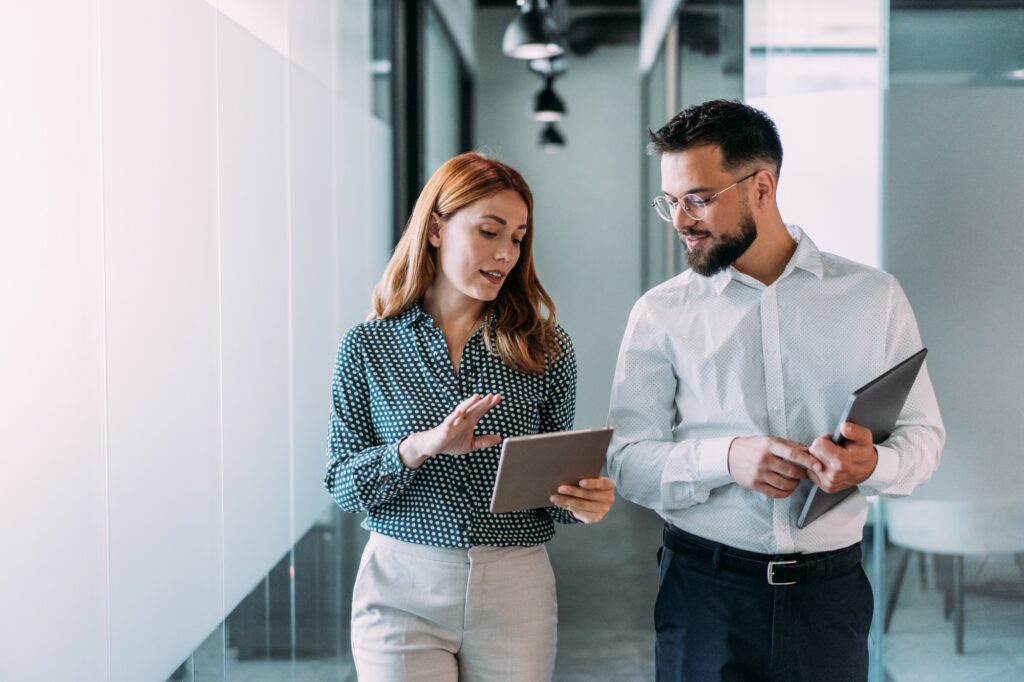 Business professionals walking with tablets