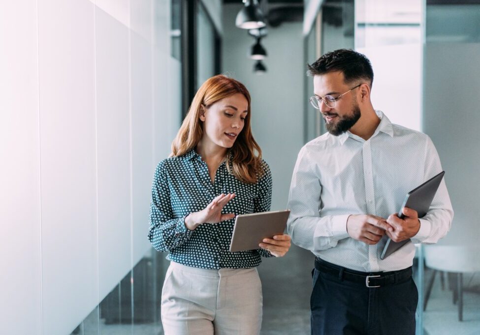 Business professionals walking with tablets